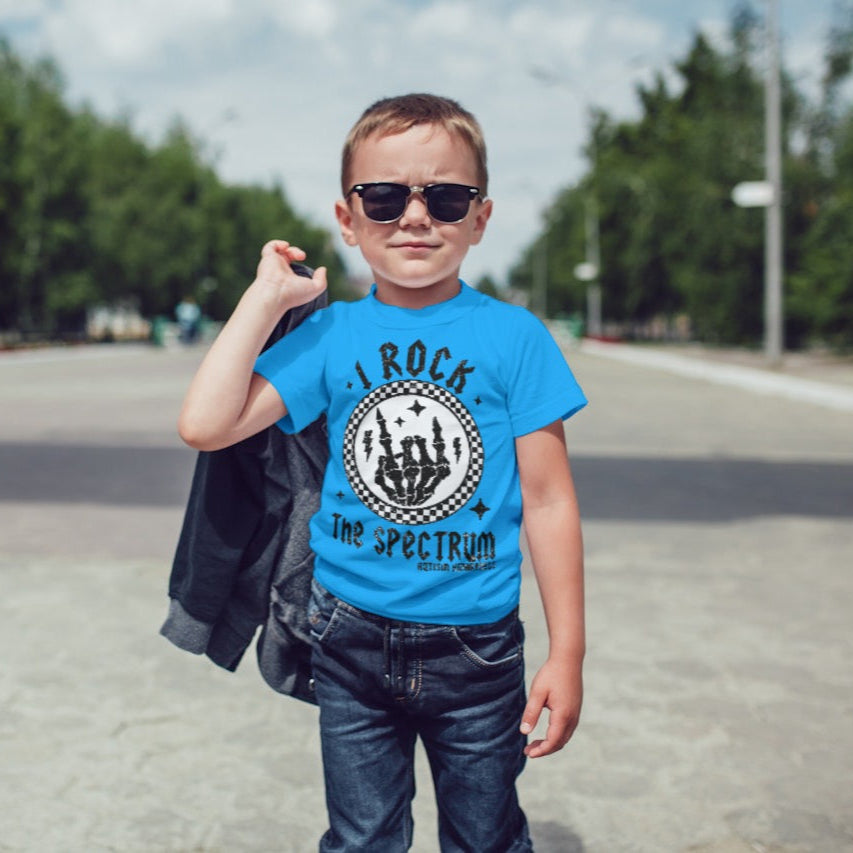 I Rock the Spectrum kids t-shirt with bold, fun design celebrating neurodiversity and autism pride. Handmade, sensory-friendly, and supporting nonverbal children with every purchase.